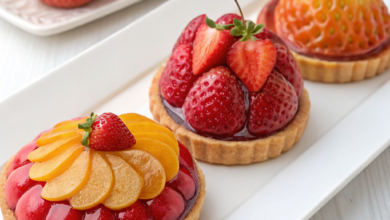 Hyper-realistic fruit-shaped pastries including a lemon, apple, and pear with gourmet chocolate shells.