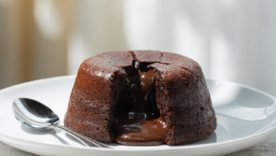 A delicious chocolate lava cake with a scoop of vanilla ice cream and a sprig of mint.