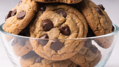 Close-up of a stack of peanut butter chocolate chip cookies on a wire rack.